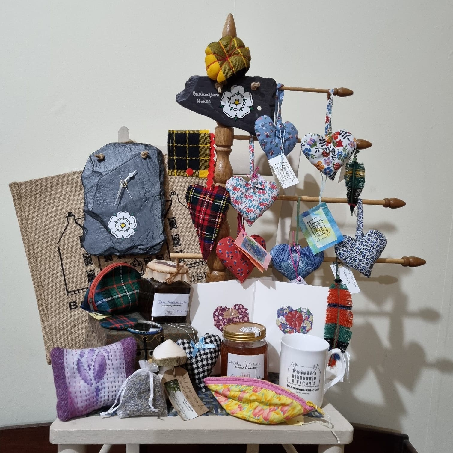 Display of items for sale within the Shop. Slate Clock, lavender hearts, mug, bag, pincushion